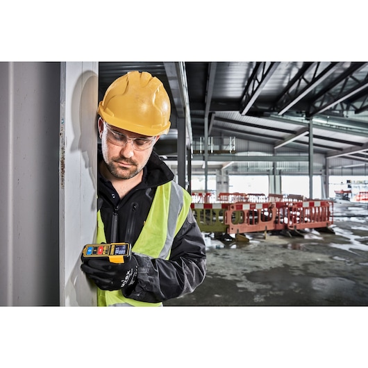 Tool Connect 100 feet laser distance measurer in action.