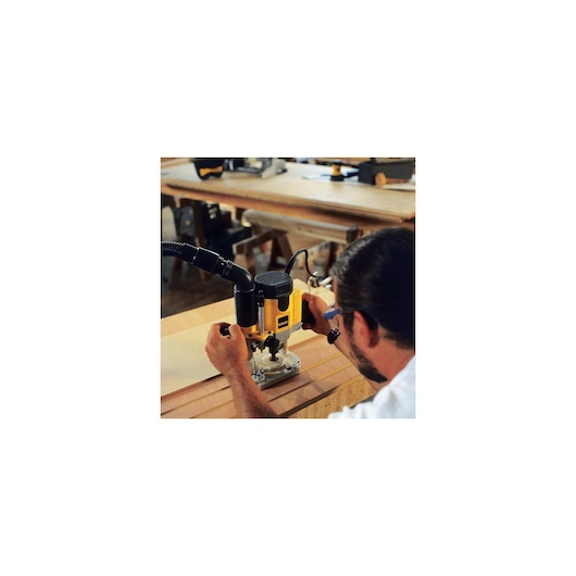 2 H P EVS Plunge router being used by a person on wood.