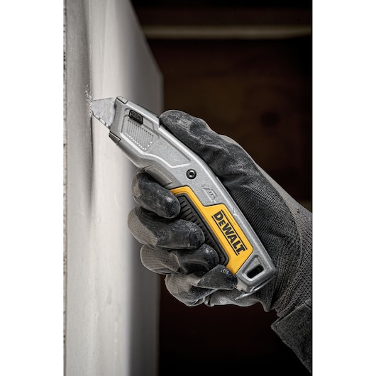 Retractable Demo Knife cutting through Drywall