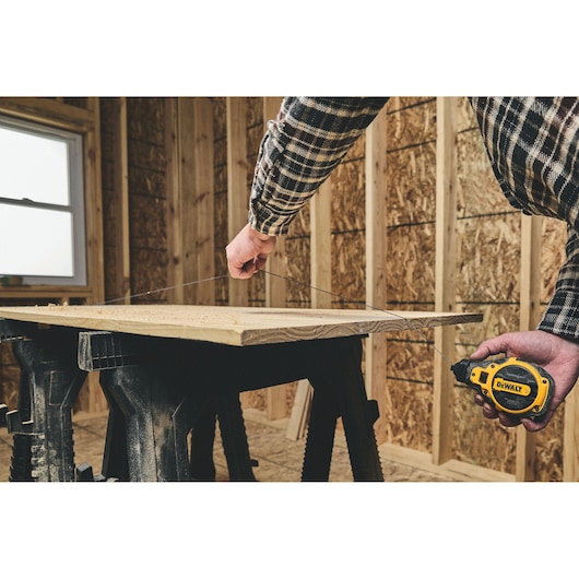Snapping a line on the DEWALT® Bi-Material Chalk Reel Kit (Blue)