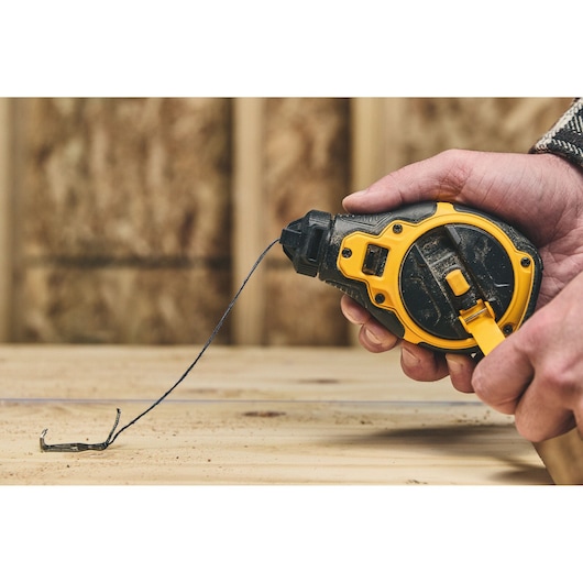 Reeling the chalk reel on the DEWALT® Bi-Material Chalk Reel Kit (Blue)