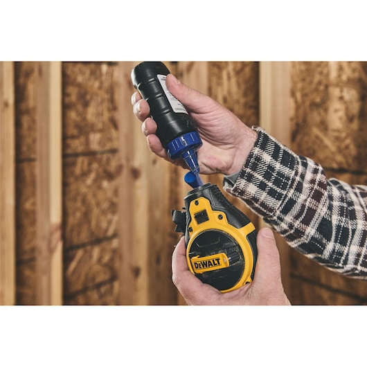 Putting blue chalk in the DEWALT® Bi-Material Chalk Reel Kit (Blue)