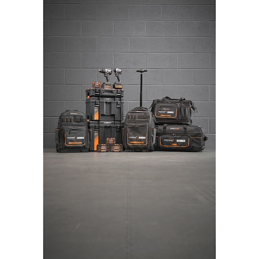 Limited Edition DEWALT/McLaren storage bags, Tstak trolley, impacts and accessory boxes stand in front of a grey wall.