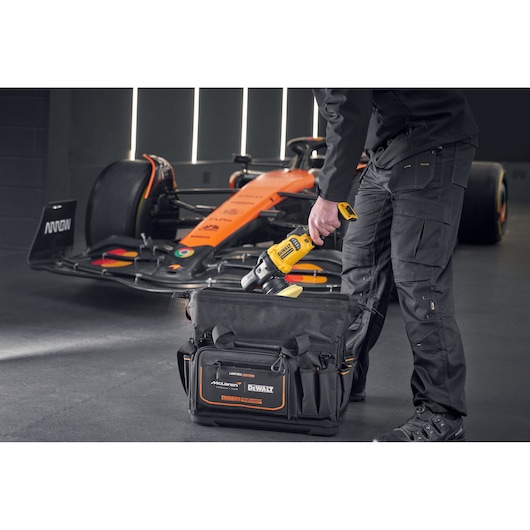 DEWALT tool being placed into a DEWALT/McLaren Tool Bag