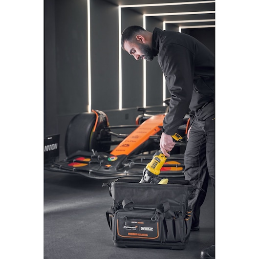 DEWALT tool being placed into a DEWALT/McLaren Tool Bag