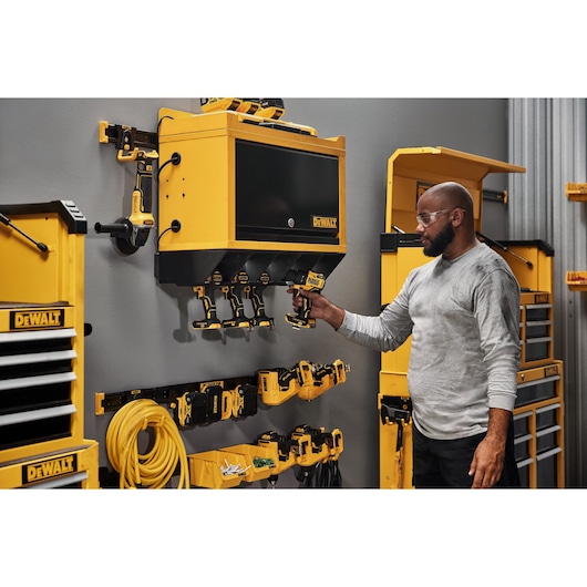 A Person Grabbing a Power Tool out of a Power Tool Holster 